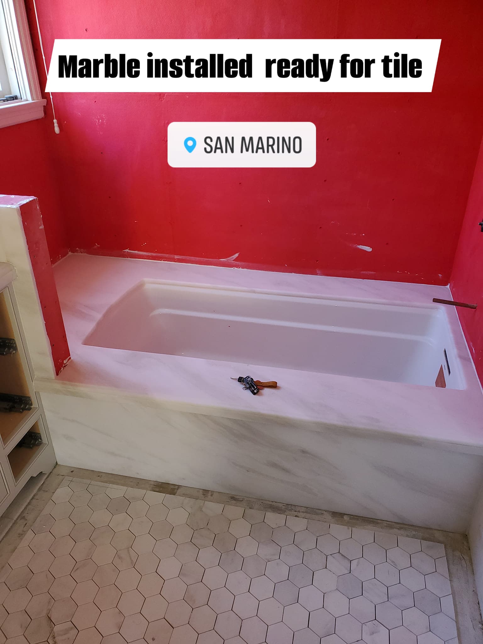 Marble tub install with hexagonal floor tile in a San Marino bathroom