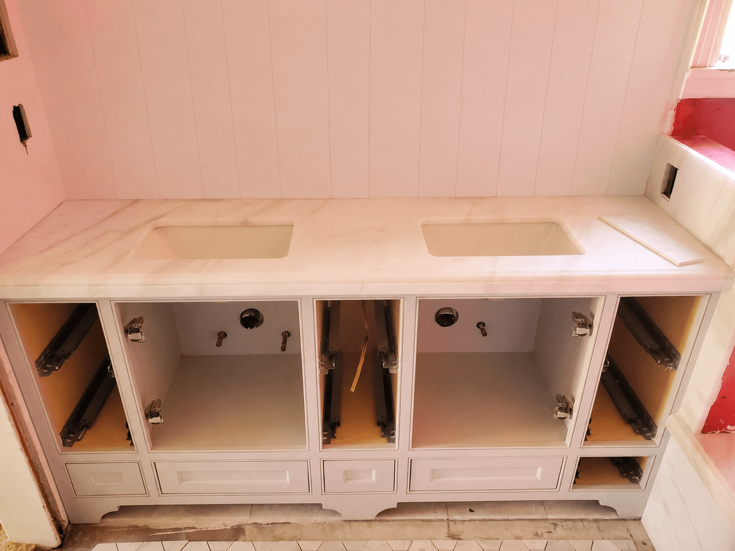 Custom marble double-sink vanity with white cabinetry in a San Marino bathroom