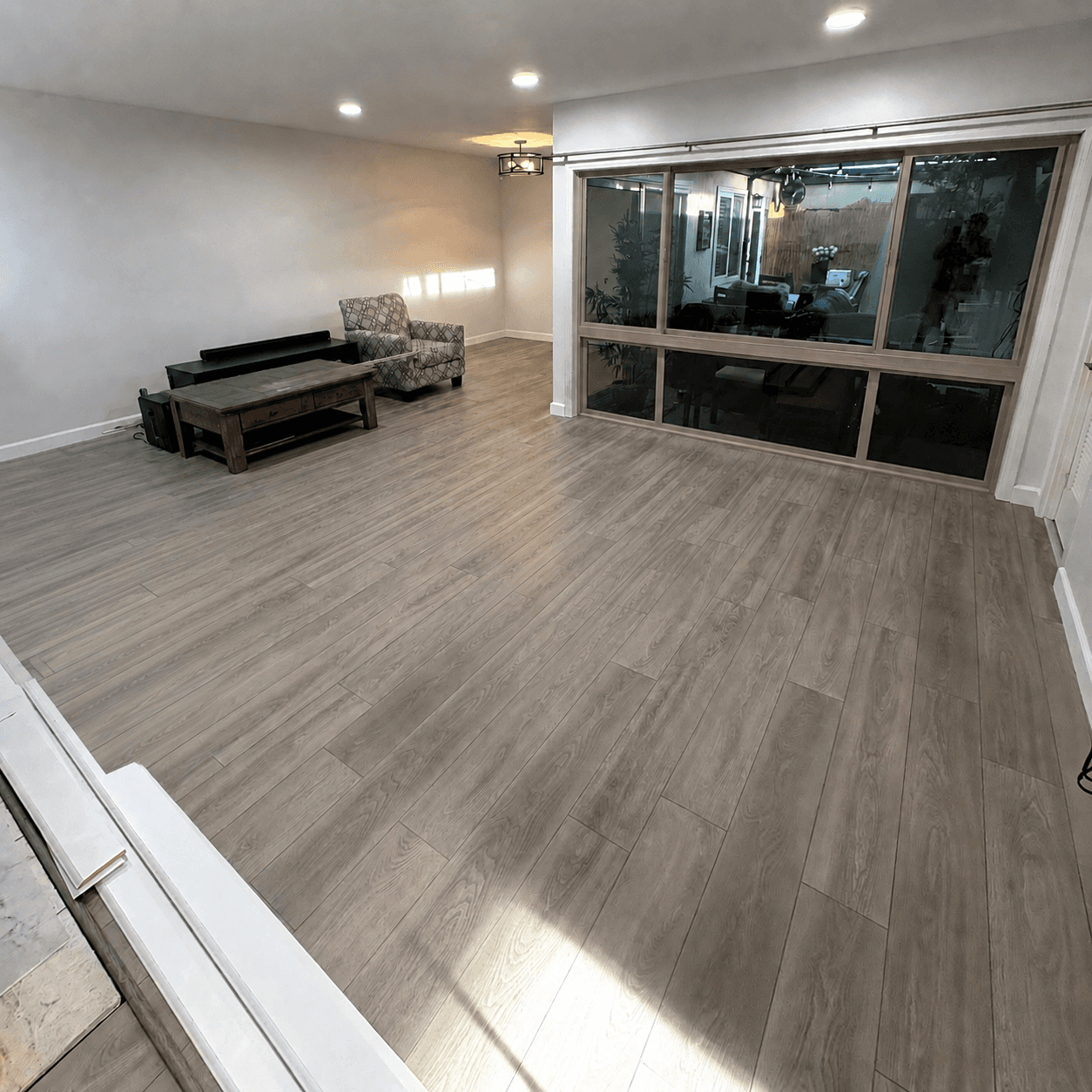 Finished interior with wood-look flooring and floor-to-ceiling glass doors